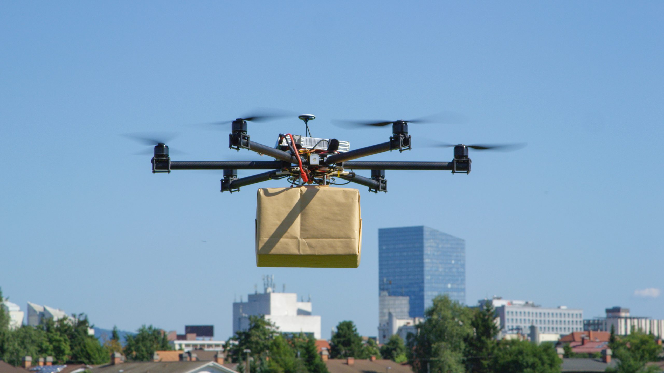 Drone delivery delivering big brown package